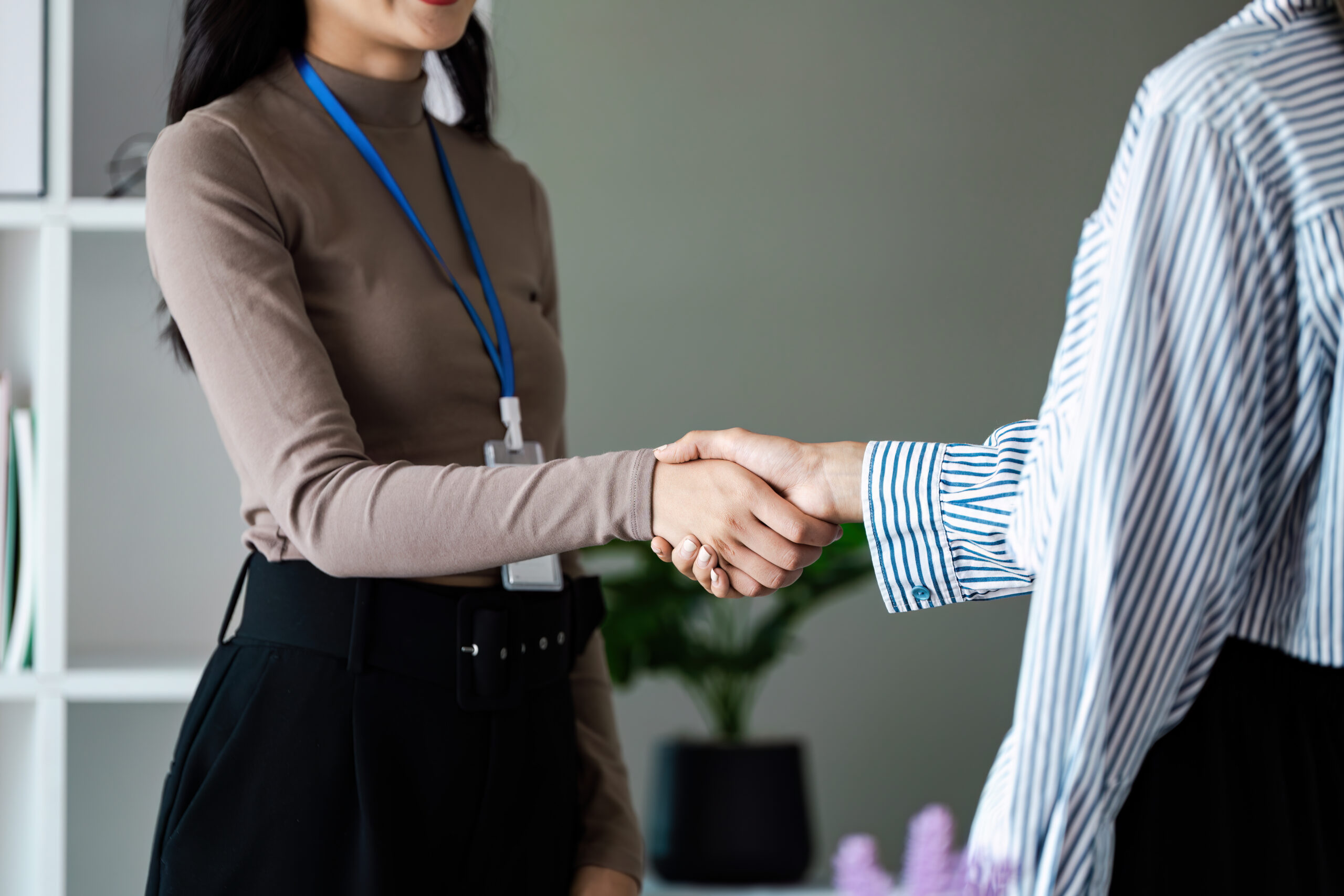 A recently hired employee shakes the hand of the recruiter at Fresh Success Marketing Group
