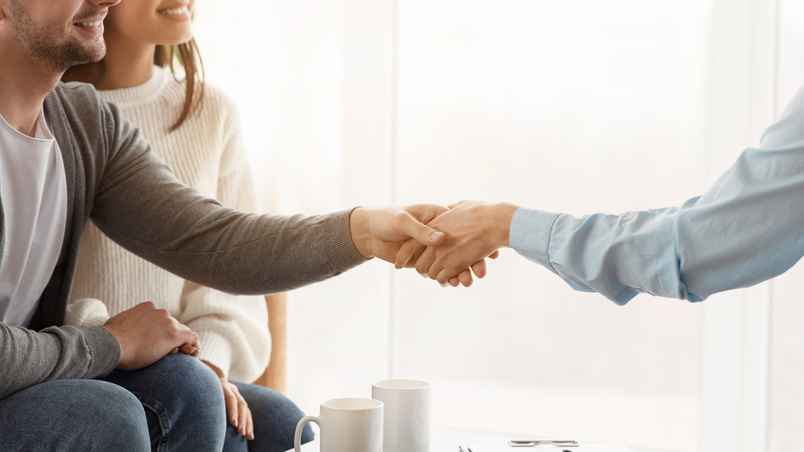 Sales representative shaking hands with customers